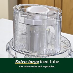Close-up of extra-large feed tube on a food processor, suitable for whole fruits and vegetables.