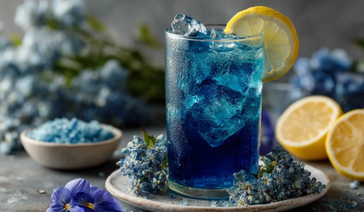 Blue Salt Trick Recipe for Men Bottle of faint blue salt water with lemon slice and Himalayan salt on a gray countertop, gym gear nearby.