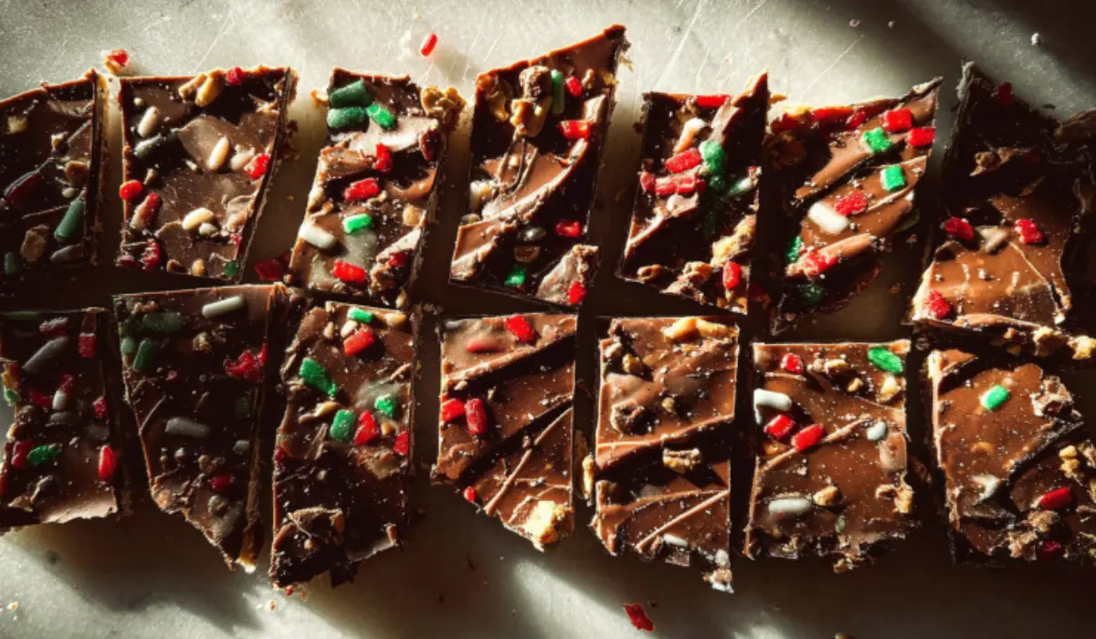 Christmas crack candy flat lay on kitchen counter showing caramel and chocolate layers topped with sea salt and pecans