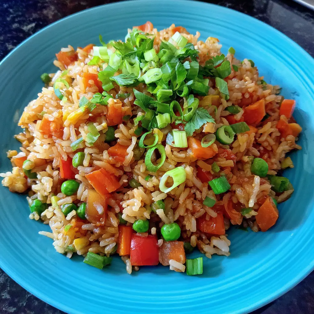 Vibrant Low-Calorie Fried Rice packed with carrots, peas, bell peppers, and fresh scallion garnish.